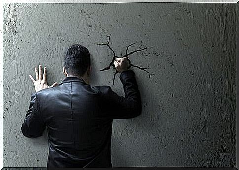 Boy punching the wall in anger