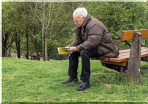 Elderly man reading a book