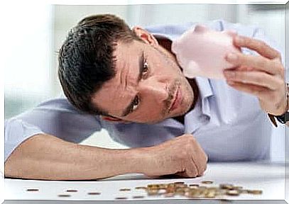 Man worried because he has few coins in the piggy bank