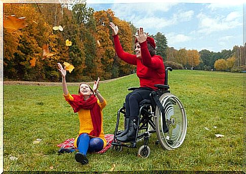 Woman in a wheelchair having fun with a friend