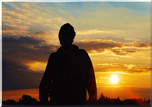 Boy in front of a sunrise