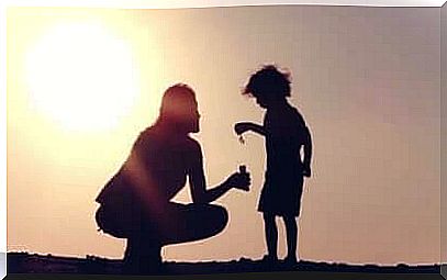 Mother and son in backlight.