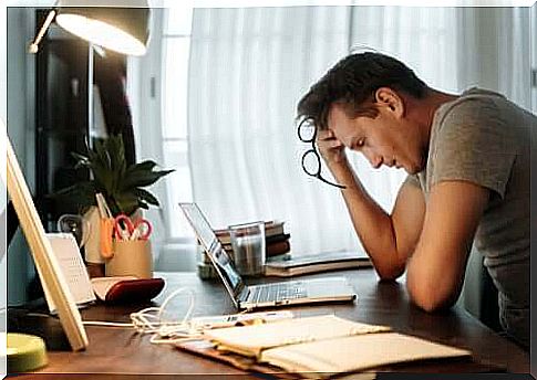 Man accusing work fatigue in front of computer