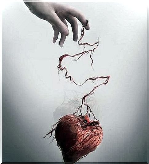 hand holding up a mistreated heart