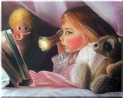 little girl reading under the covers