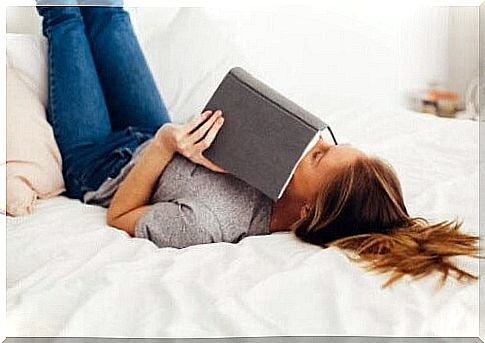 Girl in bed with a book.