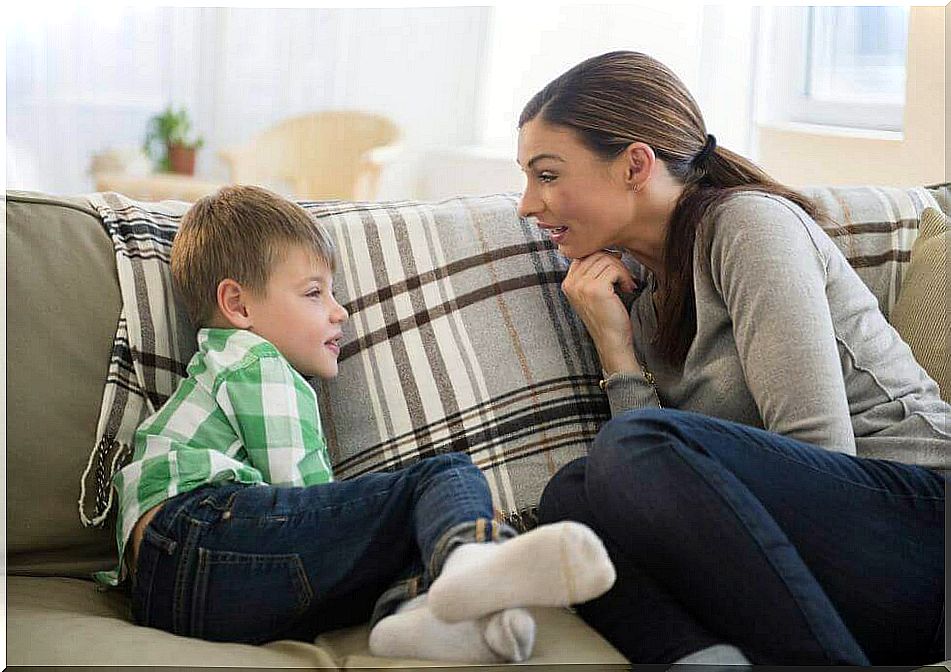 Mother and son talk sitting on the sofa