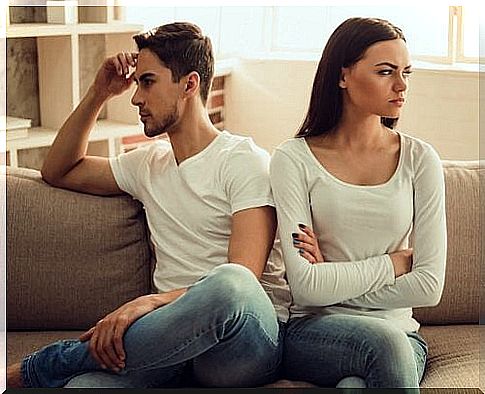 Man and woman sitting with their backs to each other