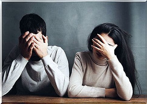 Worried couple with hands on face