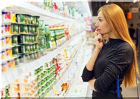 Woman pondering which yogurt to buy