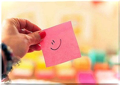 Pink post it with smiley face.