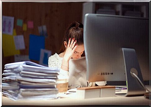 Woman in front of computer anxiously about much work